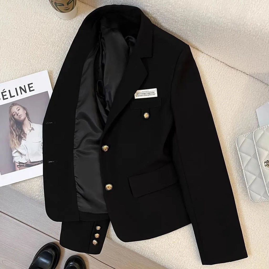 Black loose-fit women's short suit coat with long sleeves and pocket details.