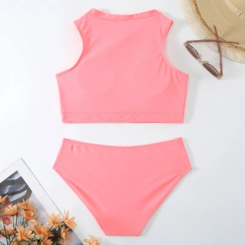 Pink high-waist split bikini swimsuit with matching bra and briefs on solid background