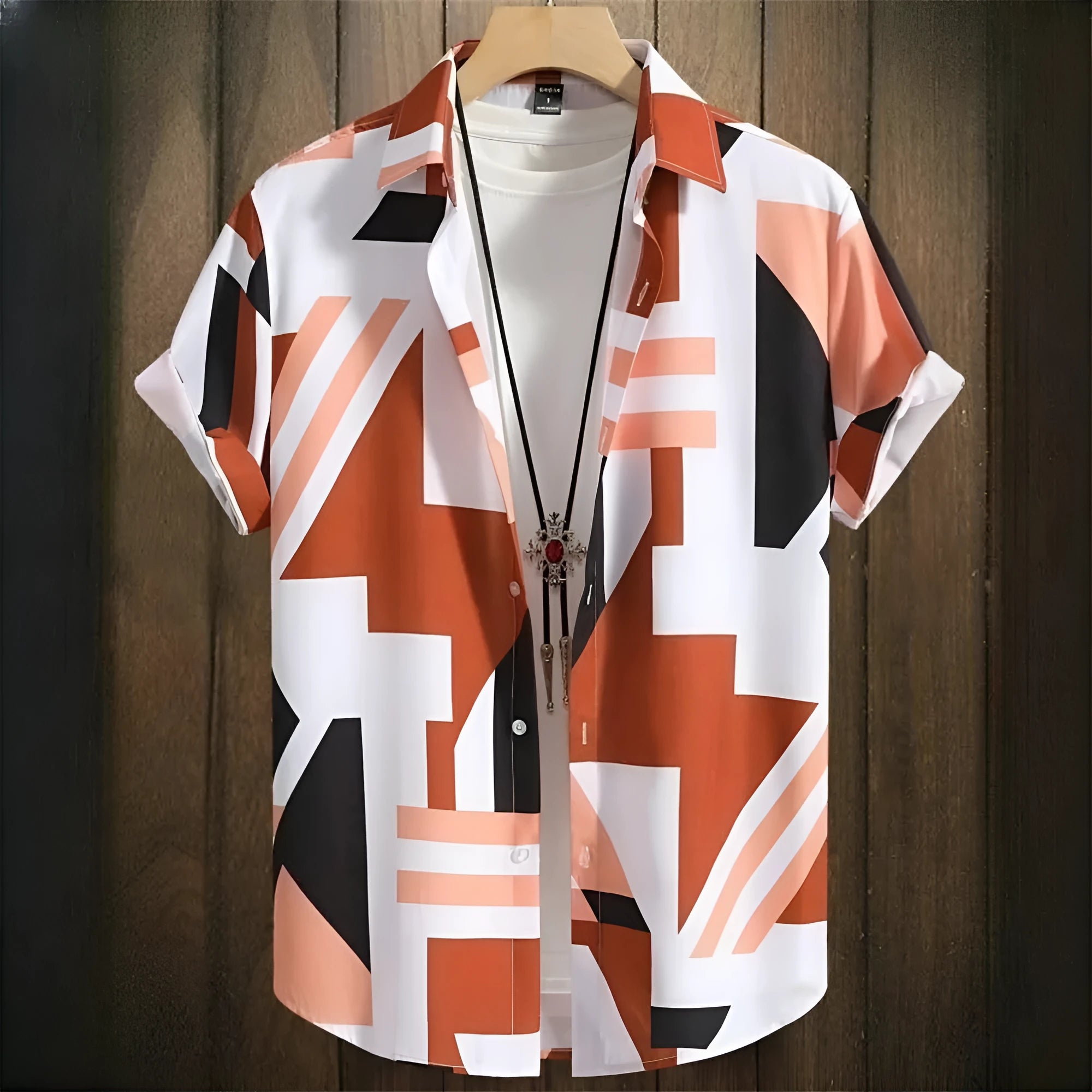 Man wearing a loose fit camouflage print short sleeve shirt in a casual cardigan style.