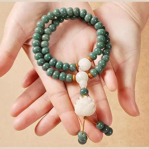 Bodhi seed bracelet with double ring safety buckle and lotus design on round beads