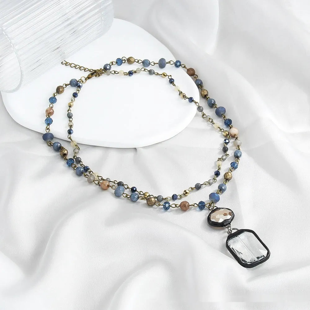 Tribal two-layer necklace with glass pendant and stone elements on adjustable chain