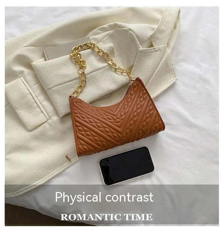 Brown pleated chain baguette shoulder bag with adjustable strap and soft carry handle