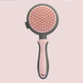 Double sided pink cat grooming brush with release button showing brush and flea comb sides