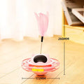 Pink cat stick toy with a tumbler turntable design on a white surface.