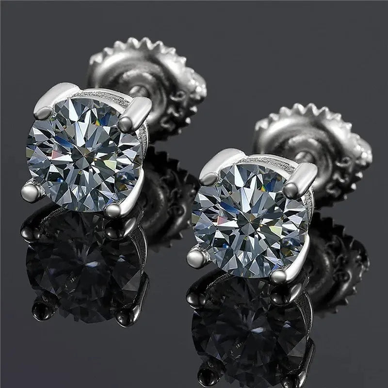 Geometric silver four claw moissanite stud earrings with screw back on black card.