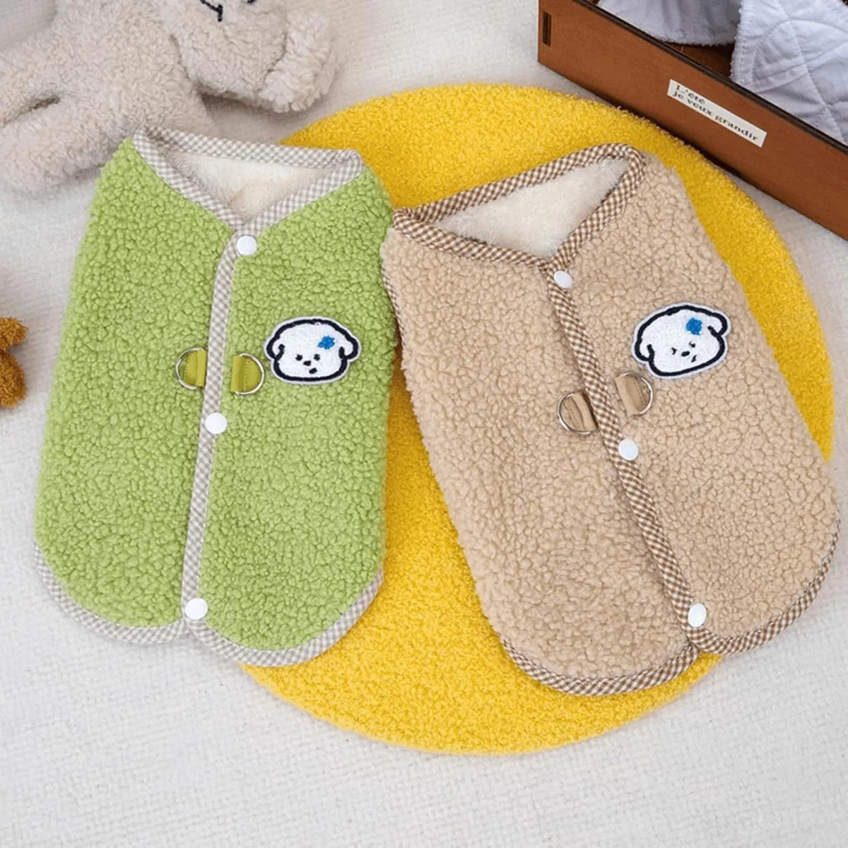 Green thickened coral fleece dog vest with a metal leash ring on the back, laid flat.