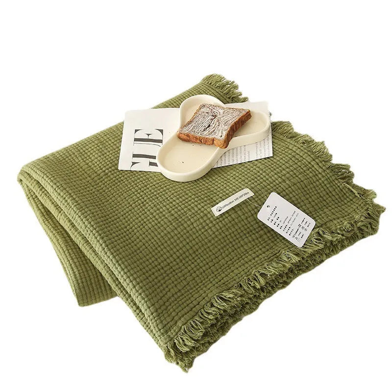 Cotton four-layer gauze blanket with tassel trim in a choice of ten colours and two sizes.