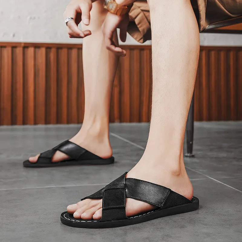 Men's black genuine leather slip-on sandals with a rubber sole on a plain background.
