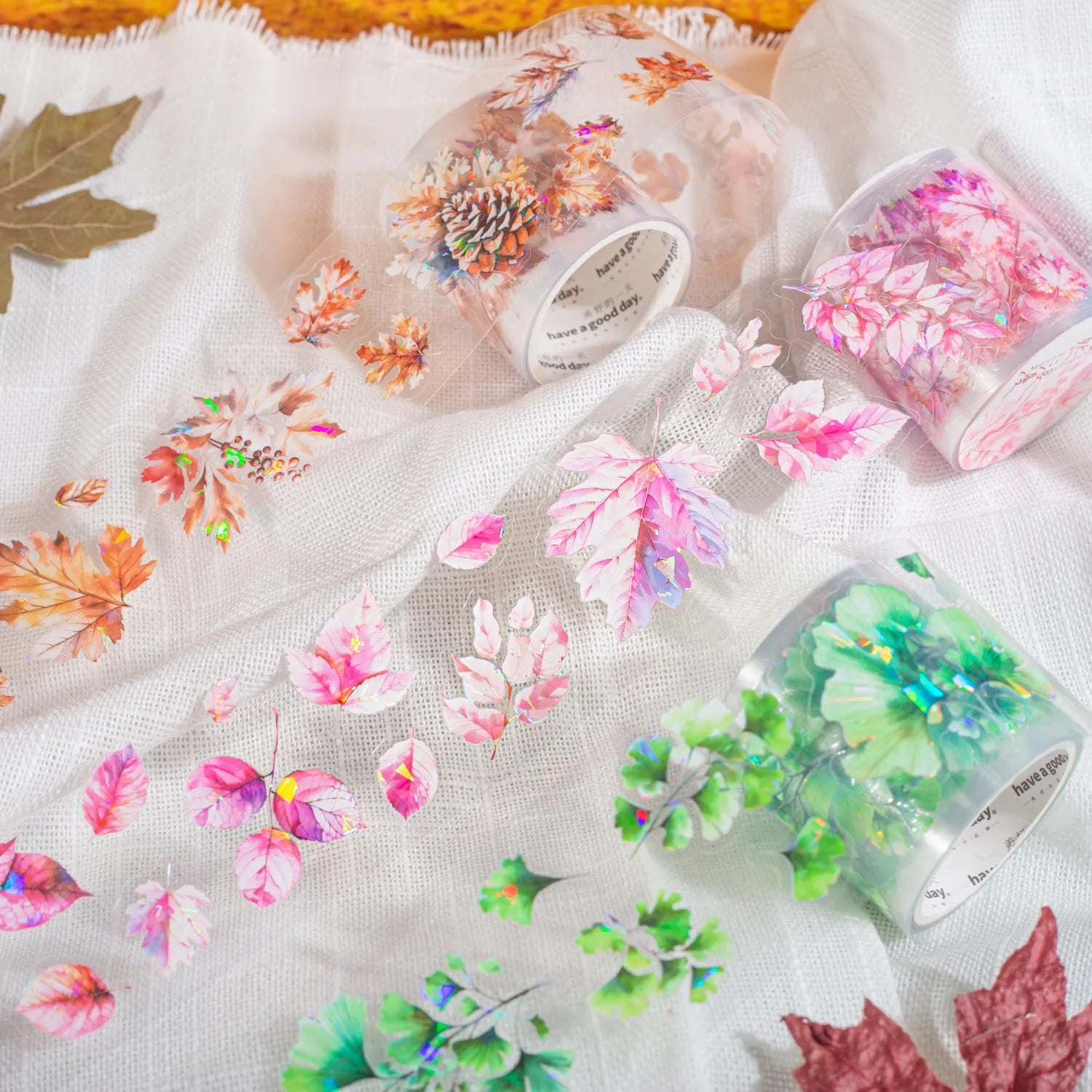 Roll of clear PET decorative stickers with repeating leaf patterns including ginkgo and maple designs.