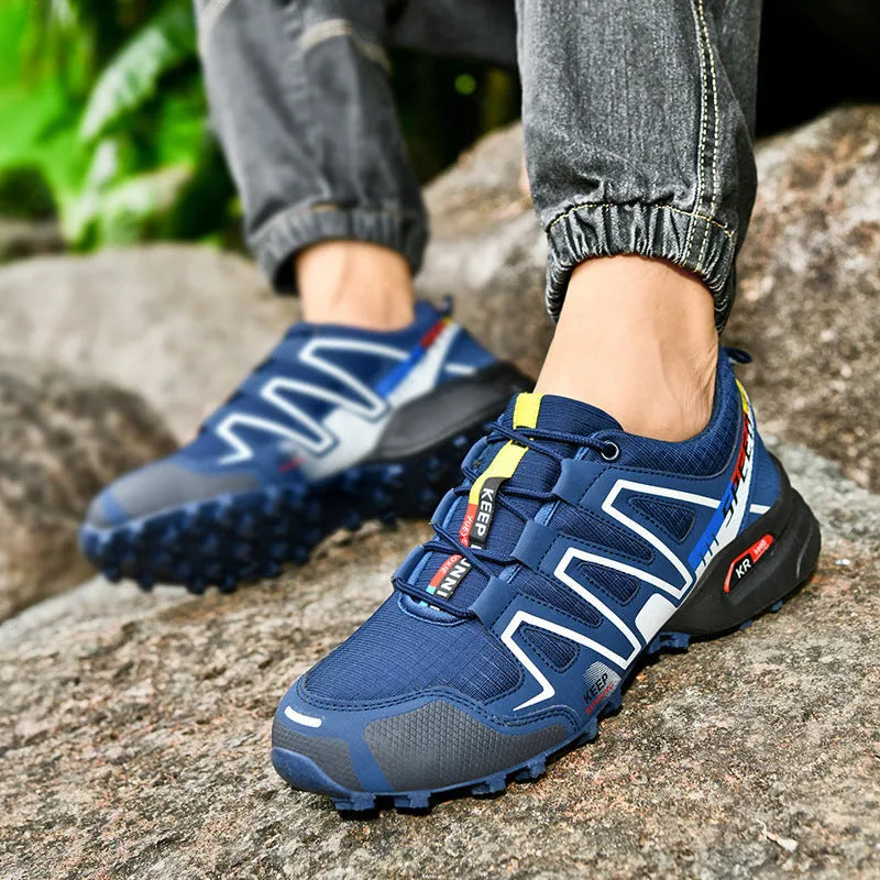 Men's plus size grey orange casual running shoes with low-top design and rubber sole.