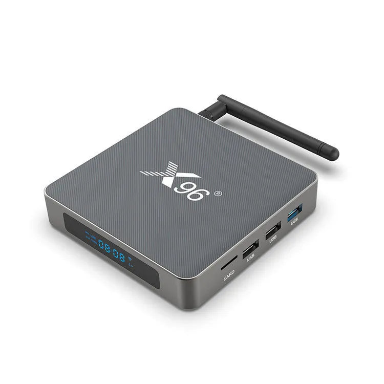 Android smart TV set-top box with voice control remote on a table next to a television.