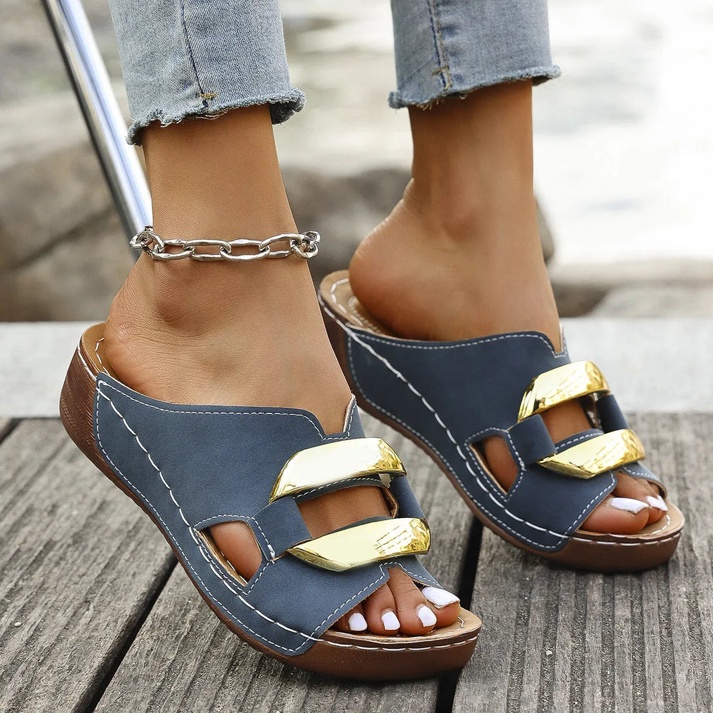 Men's white Roman-style platform sandals with a flat rubber sole and decorative metal details on the strap.