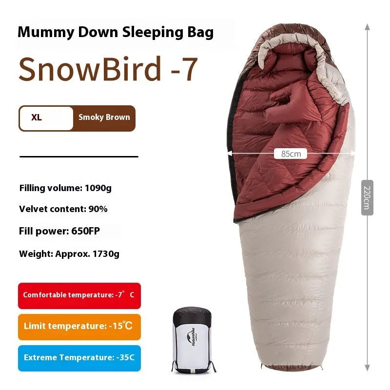 Mummy style goose down sleeping bag for adults shown with its storage bag