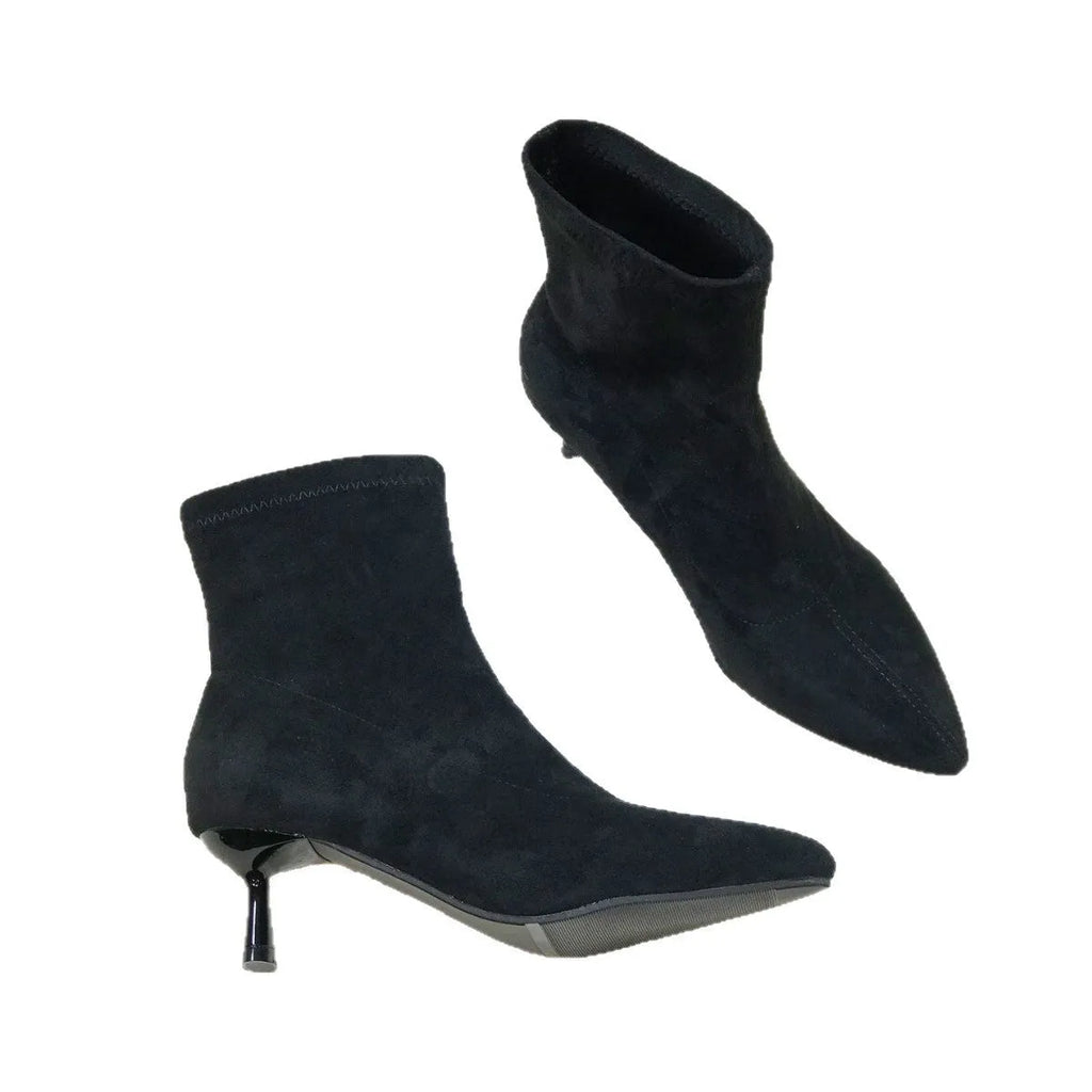 Women's black pointed toe ankle boots with stiletto heels and mid-calf length