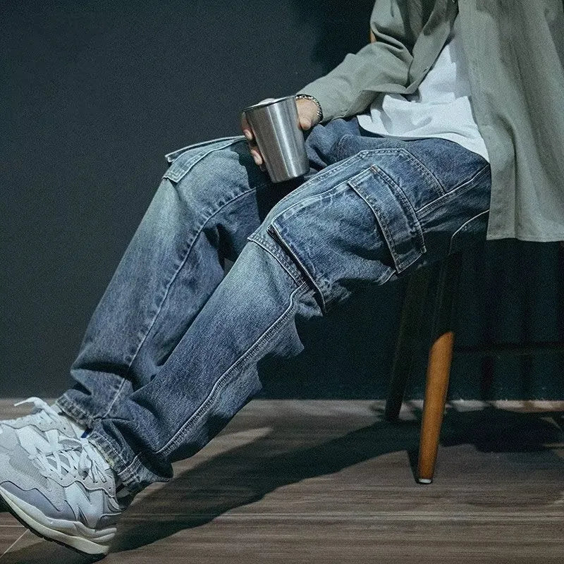 Blue loose straight-leg men's retro jeans with a zip fly on a plain background.