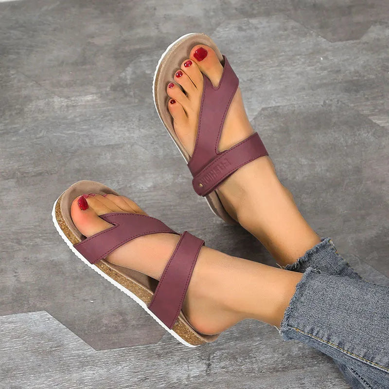 A pair of women's thick-soled flip-flops with a flat toe ring design in a solid colour.