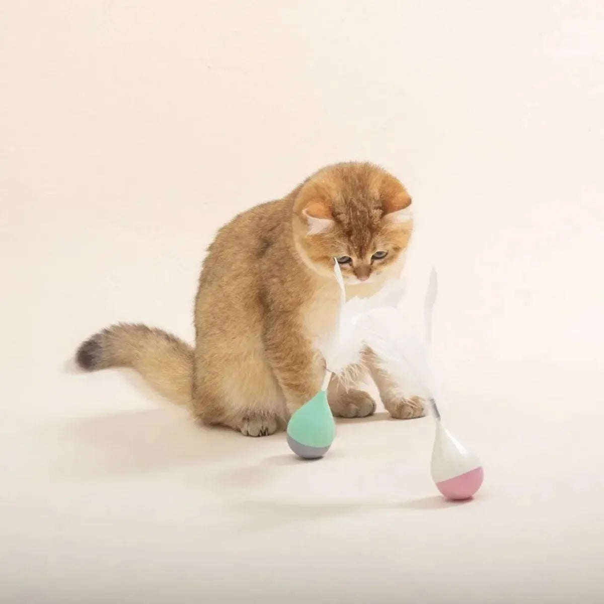 Feather tumbler cat toy with aluminium alloy construction and goose feather attachment in pink or green