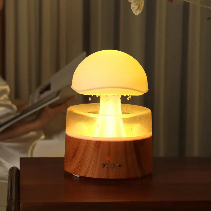 White cloud-shaped humidifier emitting mist with multi-coloured lighting and remote control