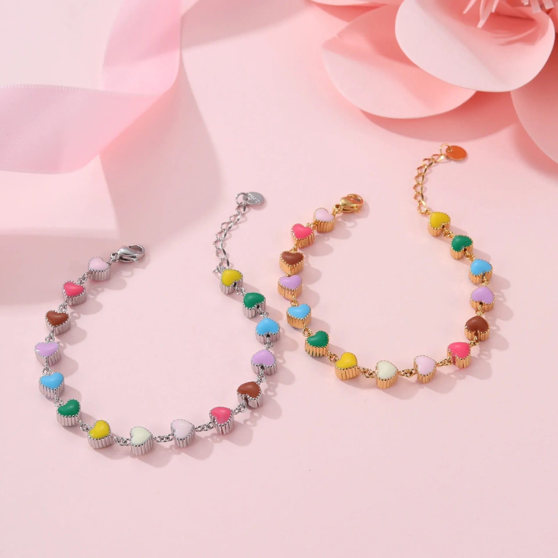 Women's stainless steel bracelet with love heart pendant featuring colourful oil finish in gold or steel colour