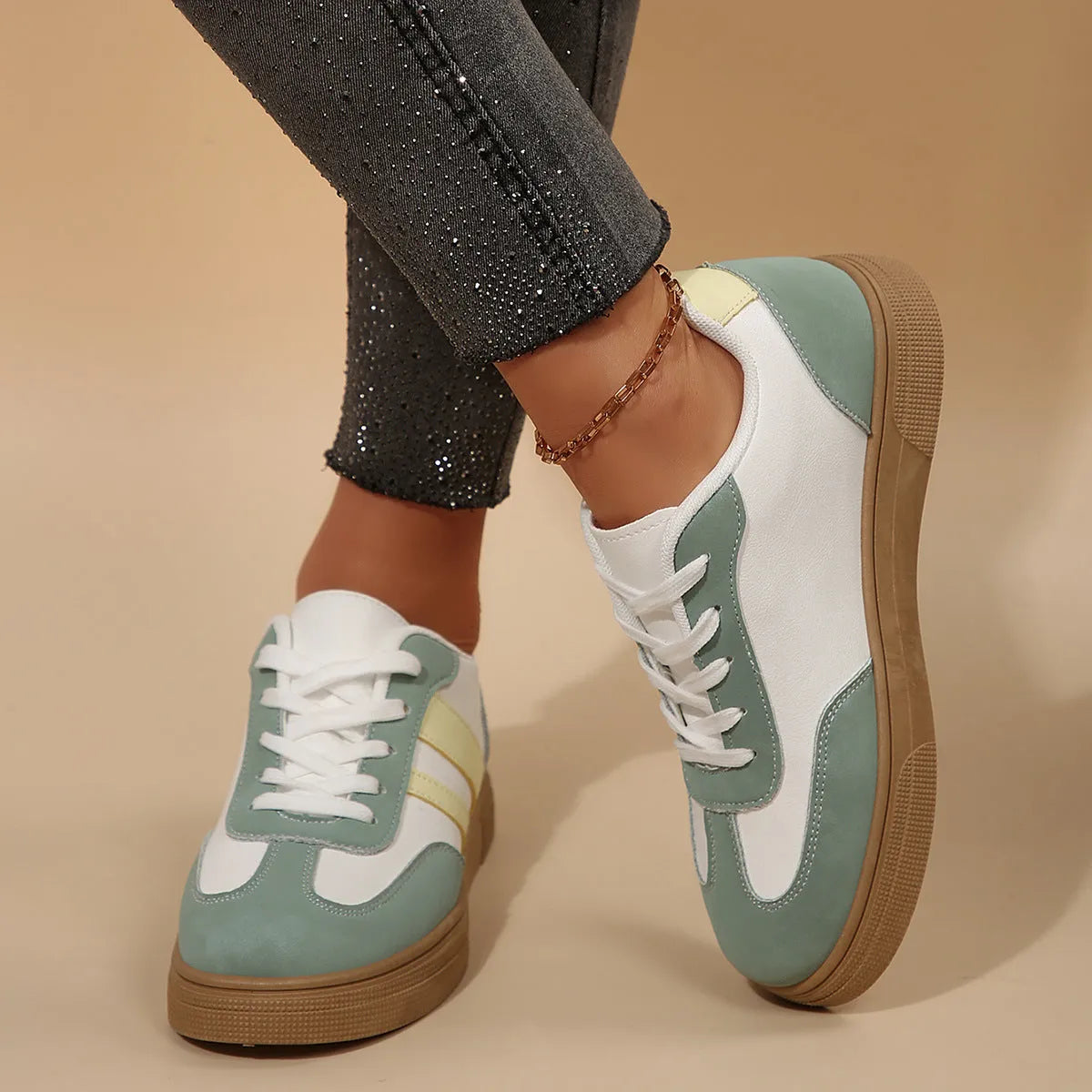 Green women's retro sports pumps with cross straps, a round toe, and a flat rubber sole.