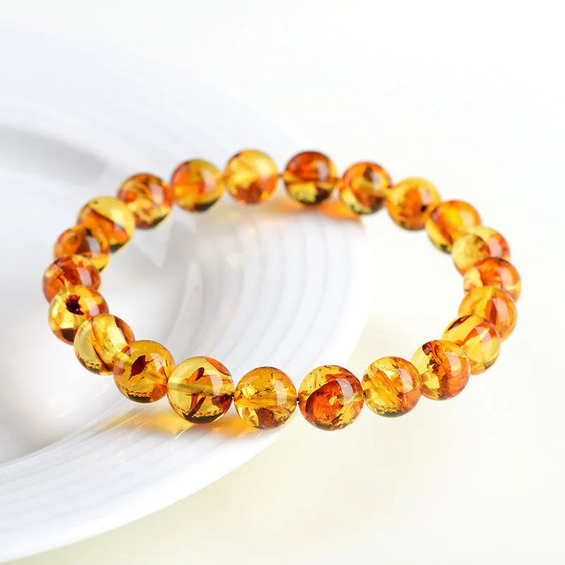 Natural yellow piebald amber bracelet with geometry beads on wrist
