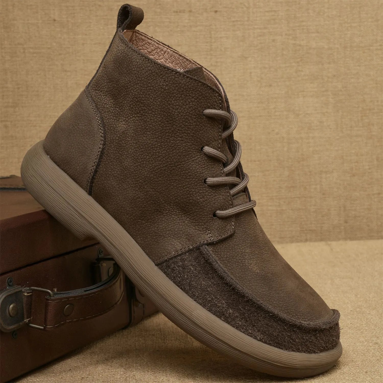 Grey genuine leather Martin boots with lace-up front and wedge heel on a plain background.