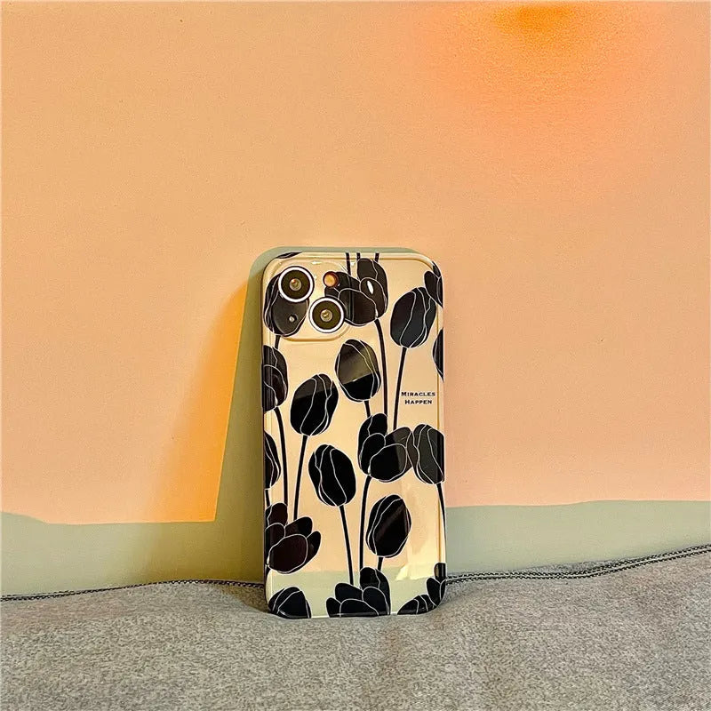 Black silicone iPhone case with a tulip floral pattern on the back.