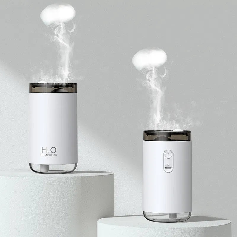 White jellyfish-shaped USB humidifier with warm night light on a wooden table.