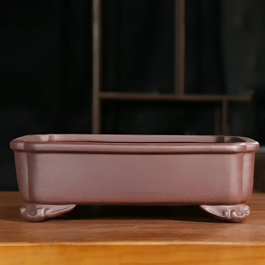 Purple sand rectangular bonsai planter with corner cutting design on wooden surface