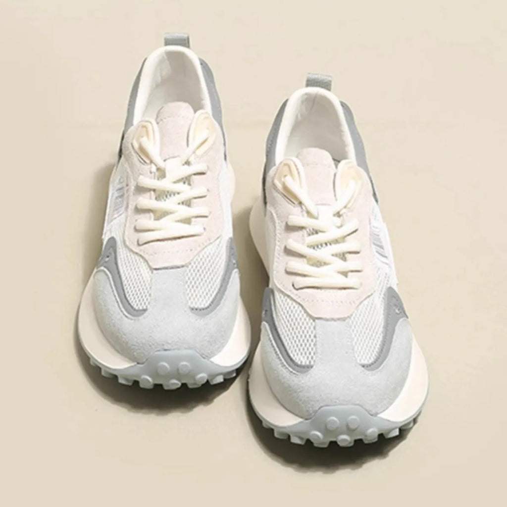 Women's grey and pink retro low-top sneaker with round toe and rubber sole.