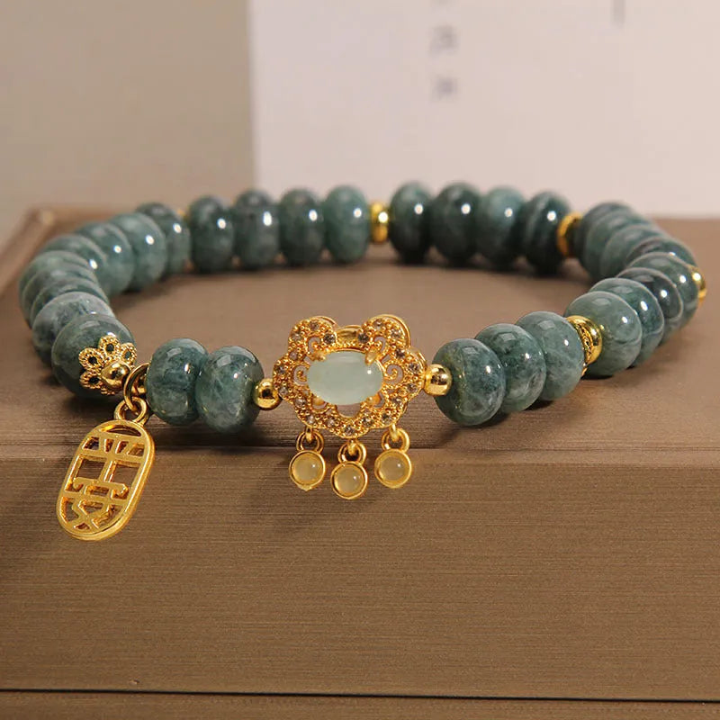 Natural emerald green jade abacus beads bracelet with a metallic alloy safety lock clasp.