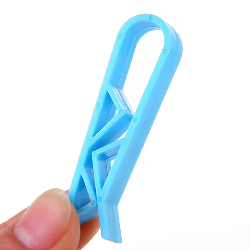 Grey PP plastic non-slip clip for fixing a bin bag to a waste bin rim.