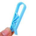 Grey PP plastic non-slip clip for fixing a bin bag to a waste bin rim.