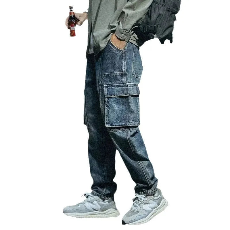 Blue loose straight-leg men's retro jeans with a zip fly on a plain background.
