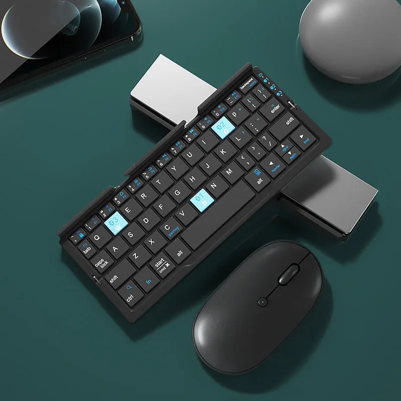 Silver folding Bluetooth keyboard open with tablet on stand, showing compact size and 60-key layout
