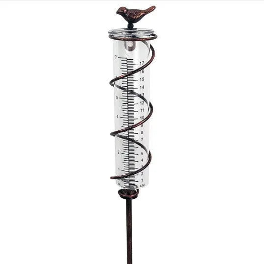 Cast iron hummingbird garden rain gauge with glass measurement tube showing 1-20 scale