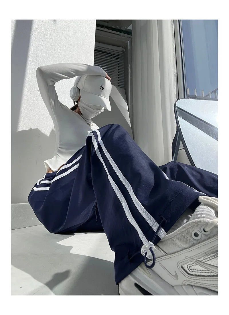 Women's navy blue loose straight leg trousers with white ribbon contrast pattern detail