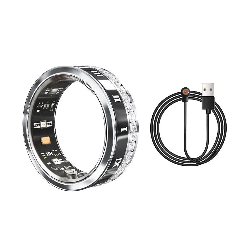 Silver and gold smart ring with diamond inlay on finger, showing charging cable and box.