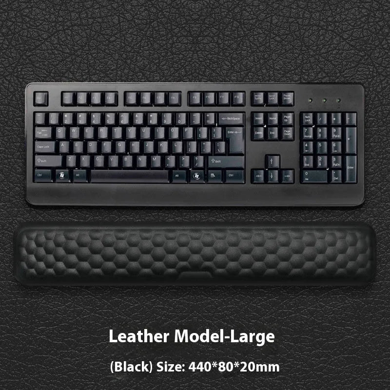 Memory foam mouse wrist pad with silicone bottom in black cloth cover on computer desk