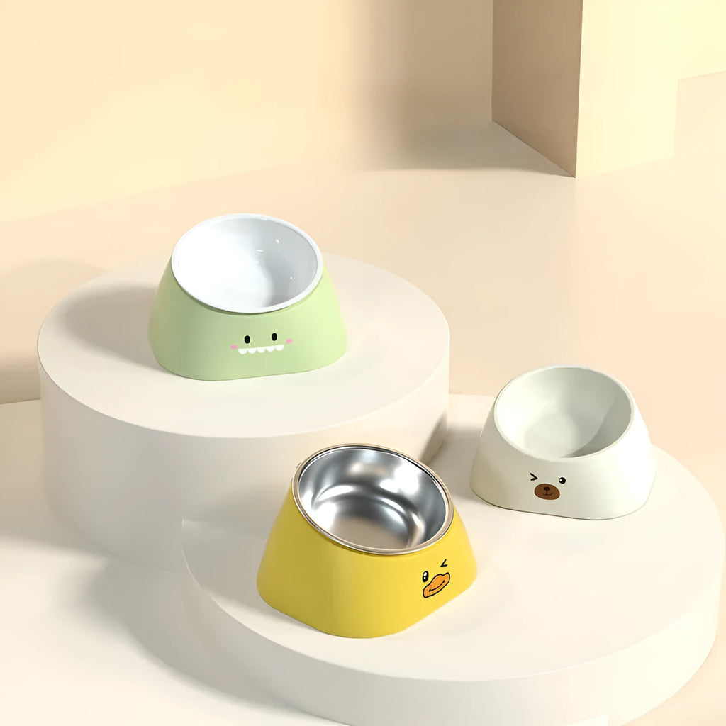 Green tilted pet bowl with stainless steel insert for cervical spine support during feeding