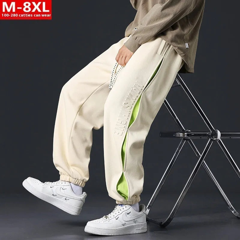 Men's loose-fit ankle banded cotton trousers with stitching detailing and skinny leg opening in grey green colour