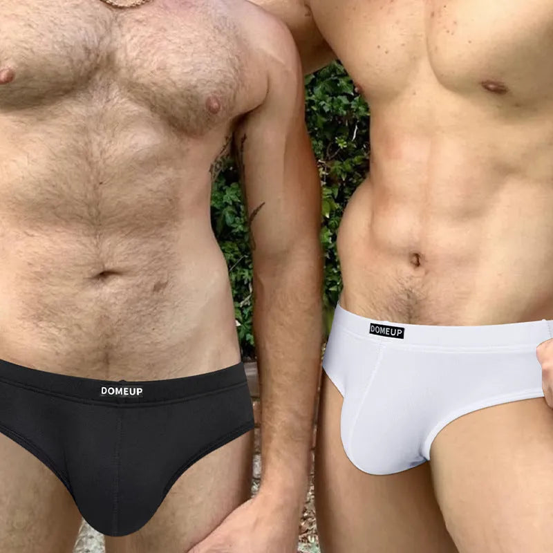 Solid colour men's seamless low waist briefs in black on a white background