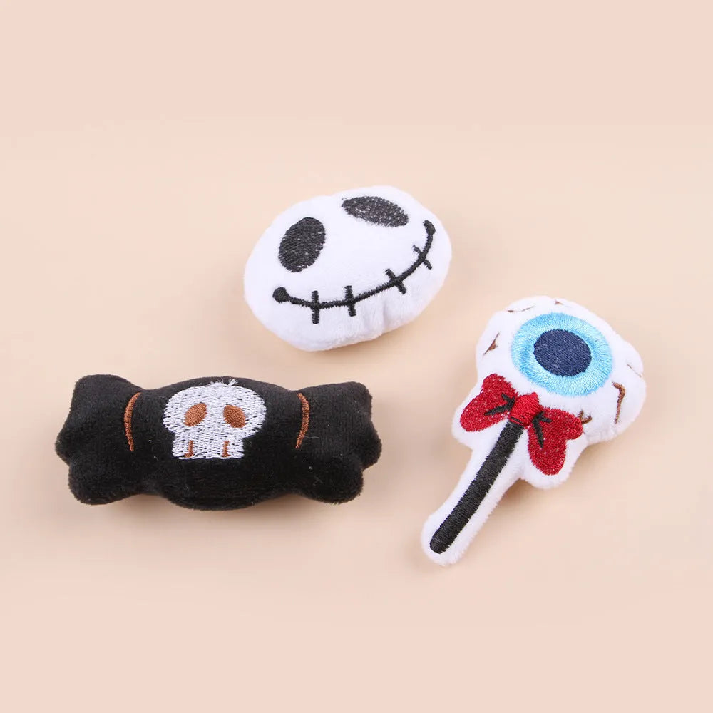 Small cat teaser toy with eyes, candy and skull plush designs on lightweight wand