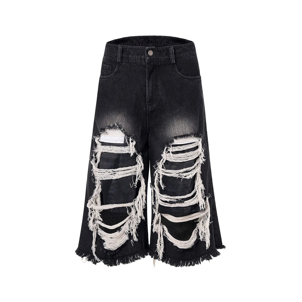 Black women's wide leg cropped jeans with ripped patch detail and a mid-high waist on a hanger.