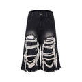 Black women's wide leg cropped jeans with ripped patch detail and a mid-high waist on a hanger.