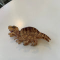 Acrylic dinosaur jaw hair clip showing six colour options including Pink Pterosaur and Blue Little Dinosaur designs