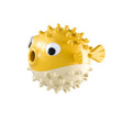 Green fish-shaped interactive dog chew toy with textured surface and internal bell.