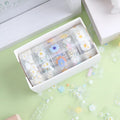 Five rolls of transparent adhesive tape with a yellow and white midsummer daisy cartoon pattern, each 1.5cm wide.