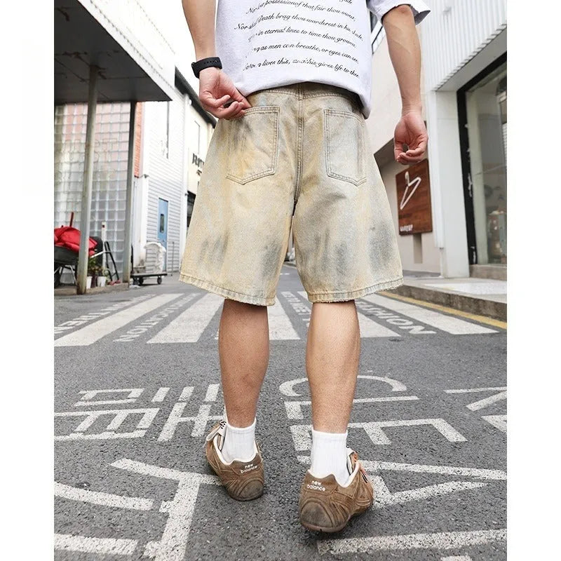 Men's light blue ripped denim shorts with straight leg style and mid-waist fit