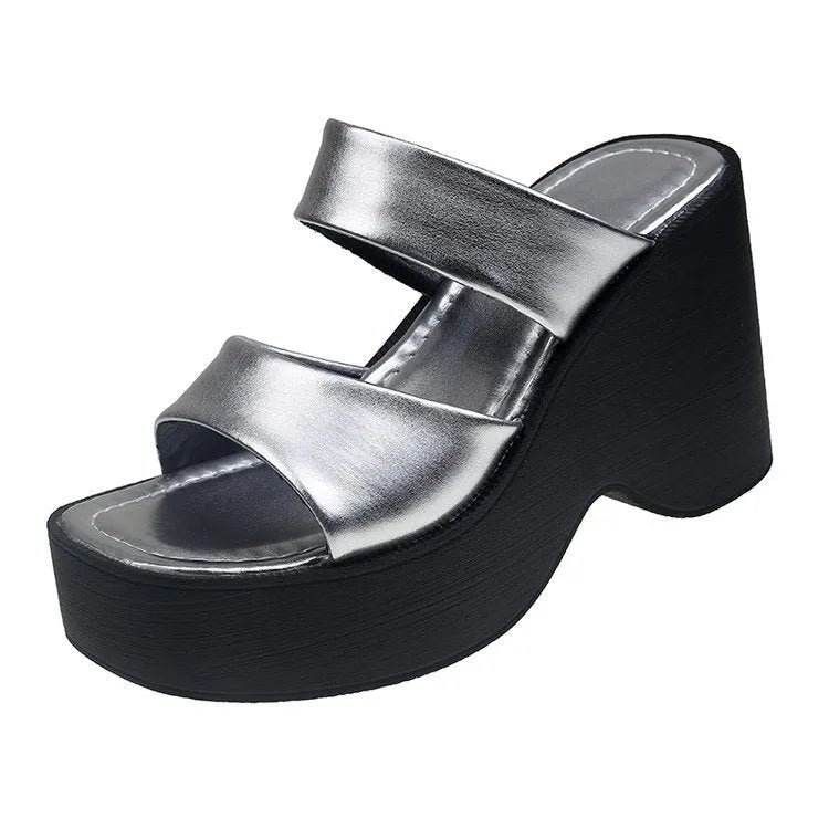 Women's black wedge platform slippers with a square toe on a plain background.
